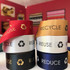 Satin ribbons in various colours, including red, gold, white, and navy, featuring recycling-themed logos and text.