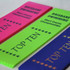 Three award ribbons in pink, green, and blue, each featuring a logo and text for a swimming championship.