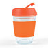 A reusable coffee cup with a transparent body and an orange silicone sleeve and lid.