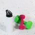 A drink bottle featuring a flip straw lid, alongside a pair of colorful dumbbells.