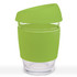 A reusable coffee cup with a transparent body and a bright green silicone lid and sleeve.