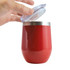 A reusable coffee cup in bright red with a silver rim and a clear lid being partially opened.
