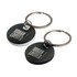 A circular stainless steel keytag in black and white with a metal keyring. Features a logo on the surface.