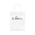 A medium white paper bag with a design featuring a parasol, palm trees, and a flamingo. It has a logo on the front.