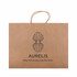 A large brown paper bag with a decorative logo and handles for carrying items.