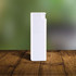A white spray bottle stands upright on a wooden surface, featuring a simple design and a small nozzle.