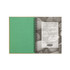 A green Stone Paper Notebook with a spiral binding, featuring a textured interior and a stone-like background.