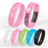 A collection of Stride Pedometer Bracelets in pink, blue, green, black, white, and transparent designs, featuring digital displays.