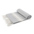 A grey blanket with white stripes and fringed edges, neatly rolled and displayed. It has a simple, elegant design.
