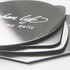 An octagonal metal coaster set featuring a shiny silver finish, stacked with a branding logo visible on top.