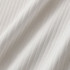 A close-up of white fabric featuring a textured ribbed design. The material appears soft and lightweight.
