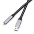 A long braided charging cable in black and silver with USB and Lightning connectors. Features a branding logo.