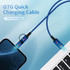 A blue braided charging cable with connectors is plugged into a smartphone and a laptop. It features a logo.