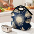 A blue neoprene lunch bag with a palm leaf design, accompanied by a stainless steel lunch container.
