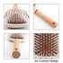 A paddle brush featuring a brown textured base, white bristles, and a wooden handle with an air cushion design.