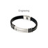 A black and silver bracelet featuring a clasp and a metallic engraving, with a logo present.