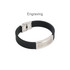 A black bracelet featuring an engraved stainless steel buckle latch, showcasing a sleek and modern design.