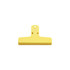 A yellow plastic magnetic clip with a flat design and a hole for hanging. It features a logo on the surface.