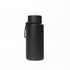 A drink bottle in matte black stainless steel, featuring a silicone handle and a lid with a metal loop.