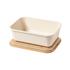 A cream-coloured lunch box with a wooden base, featuring a simple, natural design and rounded edges.