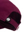 A maroon cap with a branded label on the side, featuring a curved peak and adjustable strap.