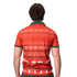 A festive orange polo shirt featuring a patterned design, including reindeer and Christmas motifs, with a green collar.