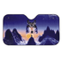 A foldable car sunshade depicting a wolf against a mountain landscape in shades of blue and purple. It has a logo.
