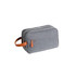 A grey toiletry bag with a leather handle and zippers. It features a simple, stylish design.