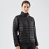 A black women's jacket featuring a quilted design, zip-up front, and high collar. The model is standing against a plain backdrop.