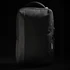 A sleek black backpack with a textured finish and a subtle logo, featuring zippered compartments and a sturdy handle.