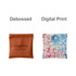 A small pocket cosmetic bag in brown with debossed design and a multicoloured floral print option. Both feature branding.