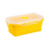 A collapsible silicone food storage container in bright yellow with a clear lid and a circular vent.
