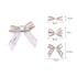 A set of hair clip bows in white and brown, featuring various sizes and styles with a silver clip.