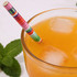 A drink bottle filled with orange liquid and ice, featuring a colourful striped 4-ply paper straw and mint leaves.