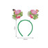 A green headband featuring pink flamingos with tropical decorations on top.