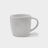A white ceramic mug with a curved handle and a smooth surface. The mug features a logo.