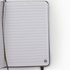 An open notebook with lined pages and a logo in the bottom corner. The cover is a neutral colour.