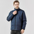 A male model wearing a navy blue puffer jacket with a high collar and zip closure. The jacket has an elasticised hem.