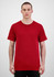 A man stands wearing a red short sleeve t-shirt. The t-shirt has a simple design and features a logo.
