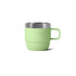 A stackable stainless steel mug in a pastel green shade with a silver rim and a sturdy handle.