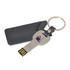 A silver flash drive shaped like a key, with a black leather pouch and keyring attached.