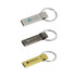 Three metal flash drives in silver, black, and gold, each attached to a keyring. Each has a logo or branding.