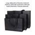 A set of black paper bags with flat handles in three sizes: small, medium, and large. Each bag has a logo.
