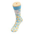 A pair of socks featuring a blue and white design with a pattern in yellow, displayed on a sock mannequin.