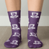 Purple socks featuring a pattern with lions and logos, showcasing a vibrant design and comfortable fit.