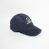A navy denim cotton baseball cap with an adjustable buckle strap and a logo on the front.