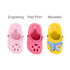 Three paw clog shoe-shaped charms in pink, light pink, and yellow with a butterfly design. Each has a moulded, engraved, or printed finish.