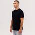 A black T-shirt displayed on a male model, paired with grey trousers. The T-shirt features no visible logos.