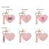 A heart-shaped compact mirror in pink features a keychain, with options for digital print and debossing designs.