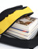 A black and yellow backpack unzipped with several stacked books visible inside. The backpack features a logo.